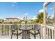 Balcony with table and chairs and tropical foliage at 318 64Th St, Holmes Beach, FL 34217