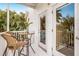 Balcony with table, chairs and tropical foliage at 318 64Th St, Holmes Beach, FL 34217