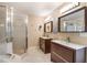 Bathroom featuring double vanities and a walk-in shower at 318 64Th St, Holmes Beach, FL 34217