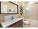 Clean bathroom featuring a tiled shower-tub combination and modern vanity at 318 64Th St, Holmes Beach, FL 34217