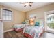 Bright bedroom featuring twin beds with floral bedding, wood floors, and light-colored walls at 318 64Th St, Holmes Beach, FL 34217
