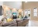 Bright living room with high ceilings, tile flooring, comfortable seating, and access to an outdoor balcony at 318 64Th St, Holmes Beach, FL 34217