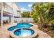 Lovely private pool and spa with brick surround, lush landscaping and outdoor seating at 318 64Th St, Holmes Beach, FL 34217