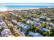 Aerial view of a coastal community, showcasing a charming home with a blue roof near the ocean at 318 64Th St, Holmes Beach, FL 34217