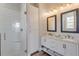 Bright bathroom features double sinks, granite counters, a glass enclosed shower and white subway tile at 32 Palm Dr, Placida, FL 33946