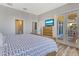Cozy bedroom with outdoor deck access, dresser, and TV on hardwood floors at 32 Palm Dr, Placida, FL 33946
