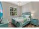 Tropical bedroom with chandelier, palm tree view, side tables, and a full bed on hardwood floors at 32 Palm Dr, Placida, FL 33946