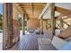 Expansive wooden deck offers outdoor living space with seating and an outdoor shower near lush landscaping at 32 Palm Dr, Placida, FL 33946