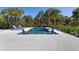A stunning backyard pool provides a tranquil and luxurious oasis surrounded by palm trees and lounge chairs at 32 Palm Dr, Placida, FL 33946