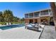 Stunning pool with 2 lounge chairs, a patio and 2nd story porch overlooking the yard at 32 Palm Dr, Placida, FL 33946