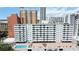 Exterior view of a modern, high-rise apartment complex with a pool and recreational area at 33 S Gulfstream Ave # 905, Sarasota, FL 34236
