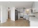 Open-concept kitchen with stainless appliances, modern gray cabinets, and light wood floors at 33 S Gulfstream Ave # 905, Sarasota, FL 34236