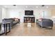 Spacious living room with tile floors, comfortable seating, and a large television at 33 S Gulfstream Ave # 905, Sarasota, FL 34236