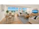 Bright living room with water view, wood floors, dining area, and comfortable seating at 33 S Gulfstream Ave # 905, Sarasota, FL 34236