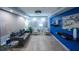 A modern lounge featuring a blue accent wall, contemporary seating, and stylish décor at 33 S Gulfstream Ave # 905, Sarasota, FL 34236