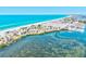 An aerial view shows a condo complex along the Gulf Coast with its beautiful blue waters at 3540 Gulf Of Mexico Drive # 202, Longboat Key, FL 34228