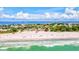 Picturesque aerial view of the beach, with turquoise waters and vibrant coastal scenery at 3540 Gulf Of Mexico Drive # 202, Longboat Key, FL 34228