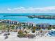 An aerial view shows a condo complex near the beach with a view of the bay at 3540 Gulf Of Mexico Drive # 202, Longboat Key, FL 34228