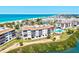 Aerial view of a community with beachfront access, a pool, and well-maintained grounds at 3540 Gulf Of Mexico Drive # 202, Longboat Key, FL 34228