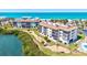 Elevated view of beachfront community and a building with well-manicured landscaping at 3540 Gulf Of Mexico Drive # 202, Longboat Key, FL 34228