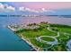 Beautiful aerial view of a waterfront community with lush greenery and city skyline in the distance at 3540 Gulf Of Mexico Drive # 202, Longboat Key, FL 34228