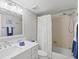 Well-lit bathroom featuring a shower over tub and a vanity with ample counter space at 3540 Gulf Of Mexico Drive # 202, Longboat Key, FL 34228