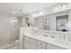 Bathroom features dual sinks, white cabinets, and a glass enclosed shower at 3540 Gulf Of Mexico Drive # 202, Longboat Key, FL 34228