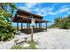 Private beach access with a shaded shelter, offering a serene coastal retreat at 3540 Gulf Of Mexico Drive # 202, Longboat Key, FL 34228