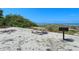 Beachside picnic area with a table and grill, perfect for enjoying outdoor meals at 3540 Gulf Of Mexico Drive # 202, Longboat Key, FL 34228