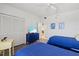 This well-lit bedroom has twin beds, closet, and seahorse decor with easy access to the doorway at 3540 Gulf Of Mexico Drive # 202, Longboat Key, FL 34228