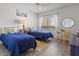 Bright bedroom with twin beds, nautical decor, and plenty of natural light from the window at 3540 Gulf Of Mexico Drive # 202, Longboat Key, FL 34228