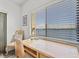 A desk with drawers, a lamp, and a comfortable chair provides a work from home space at 3540 Gulf Of Mexico Drive # 202, Longboat Key, FL 34228