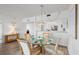 Bright dining area featuring a glass table, four chairs and access to living room and kitchen at 3540 Gulf Of Mexico Drive # 202, Longboat Key, FL 34228