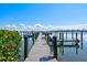 Private wooden dock extending into the tranquil water, perfect for boating and relaxation at 3540 Gulf Of Mexico Drive # 202, Longboat Key, FL 34228
