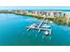 Scenic view of the condo complex private dock with boat slips and beautiful blue water views at 3540 Gulf Of Mexico Drive # 202, Longboat Key, FL 34228