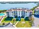 Well-maintained complex with lush landscaping, a pool, and ample parking for residents and guests at 3540 Gulf Of Mexico Drive # 202, Longboat Key, FL 34228