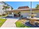 Welcome center featuring inviting entrance, lush landscaping, and tiered water fountain at 3540 Gulf Of Mexico Drive # 202, Longboat Key, FL 34228