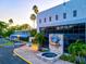 Exterior view of a marine laboratory with well-manicured landscaping, a fountain and ample parking at 3540 Gulf Of Mexico Drive # 202, Longboat Key, FL 34228