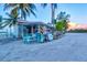 Cute and colorful fishing shop on the beach with picnic tables and palm trees at 3540 Gulf Of Mexico Drive # 202, Longboat Key, FL 34228