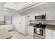 Bright kitchen featuring white cabinets, stainless steel appliances, and ample counter space at 3540 Gulf Of Mexico Drive # 202, Longboat Key, FL 34228