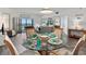 Bright living area featuring dining table and access to the screened in porch at 3540 Gulf Of Mexico Drive # 202, Longboat Key, FL 34228
