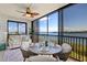 Screened patio features a dining table set and comfortable seating with amazing water views at 3540 Gulf Of Mexico Drive # 202, Longboat Key, FL 34228