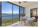 Dine al fresco on this patio with water views and sliding glass doors to the interior at 3540 Gulf Of Mexico Drive # 202, Longboat Key, FL 34228