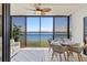 Screened in porch featuring dining table and chairs with water views at 3540 Gulf Of Mexico Drive # 202, Longboat Key, FL 34228
