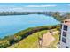 Scenic water view with lush greenery and a building featuring tiled roofing at 3540 Gulf Of Mexico Drive # 202, Longboat Key, FL 34228