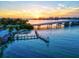 Picturesque waterfront featuring a bridge, docks, beach, and beautiful sunset views at 3540 Gulf Of Mexico Drive # 202, Longboat Key, FL 34228
