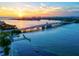 A waterfront view shows a bridge with an incredible sunset over the water at 3540 Gulf Of Mexico Drive # 202, Longboat Key, FL 34228