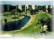 Scenic aerial view of a golf course and community with water feature and lush greenery at 3620 Ironwood Cir # 506-O, Bradenton, FL 34209