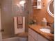 Bathroom featuring a glass shower door, granite countertop, and warm lighting at 3620 Ironwood Cir # 506-O, Bradenton, FL 34209
