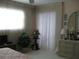 Bright bedroom with a large window, dresser, and cozy decor at 3620 Ironwood Cir # 506-O, Bradenton, FL 34209